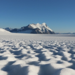 Castleguard Peak rises above sunpocked deserts cape of the Columbia Icefield, Alberta
